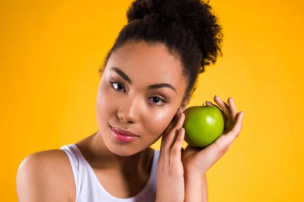 Afrikanische Amerikanerin hält Apfel isoliert. — Stockfoto