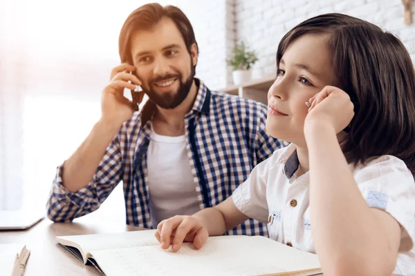 Bearded father helps young son to do school homework. — Stock Photo, Image