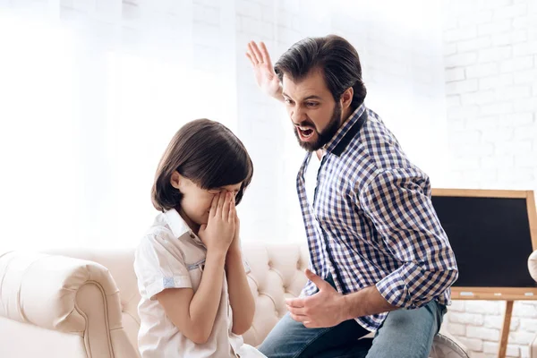 Bearded angry father raised hand on weeping son.