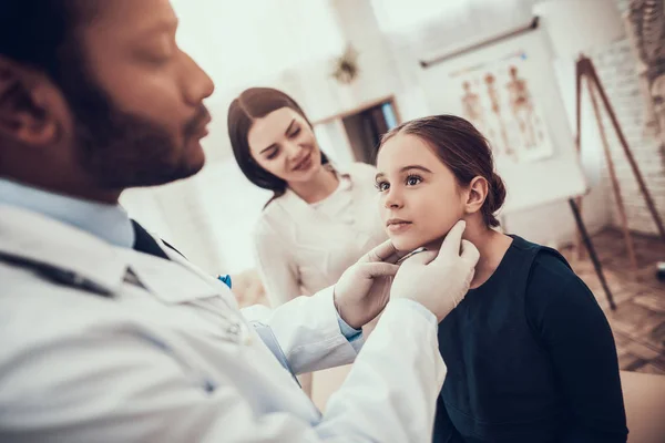 Indian doctor seeing patients in office. Doctor is examining daughter. — Stock Photo, Image