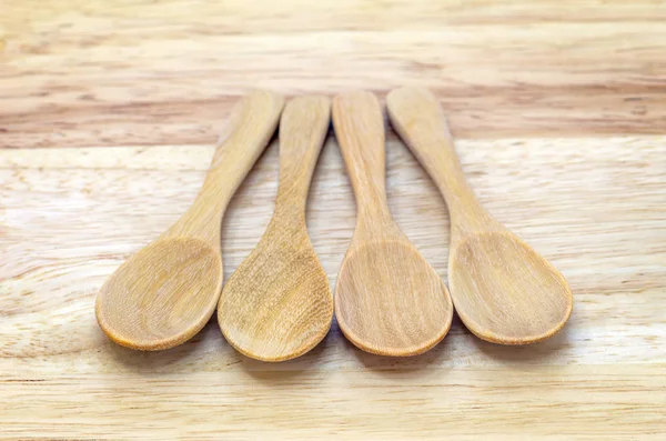 Four empty wooden spoons — Stock Photo, Image