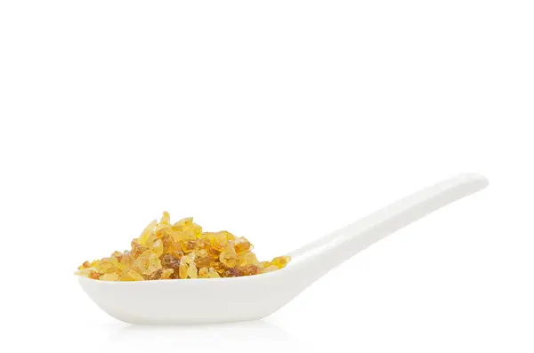 Rock sugar on white spoon — Stock Photo, Image