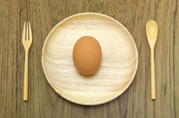 Egg with wooden spoon — Stock Photo, Image