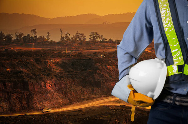 Engineer holding white helmet