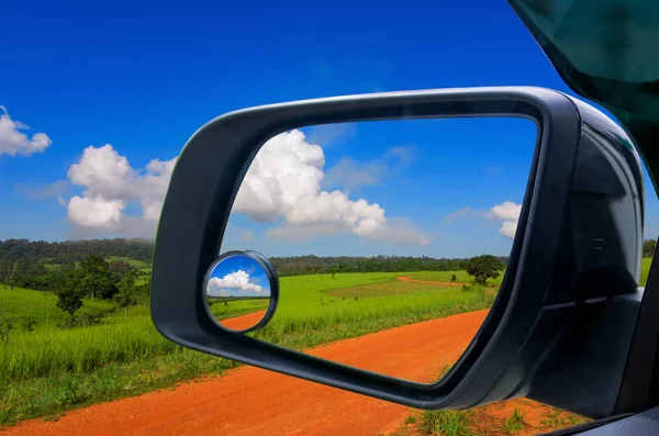 Landscape in car mirror — Stock Photo, Image