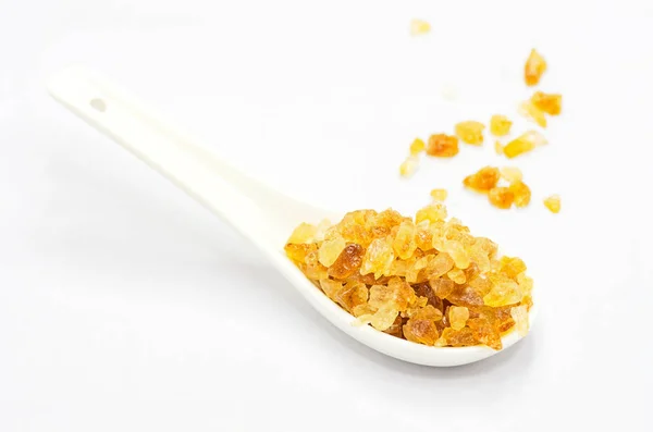 Rock sugar on white spoon — Stock Photo, Image