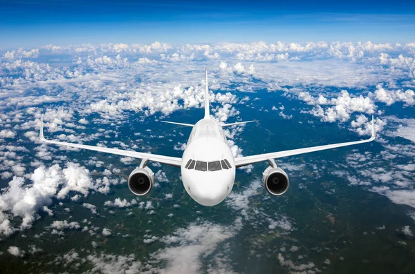 plane flying above clouds