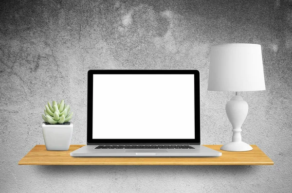 Laptop and lamp with cactus on bookshelf