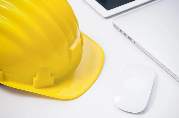 stock image desk with engineer yellow helmet