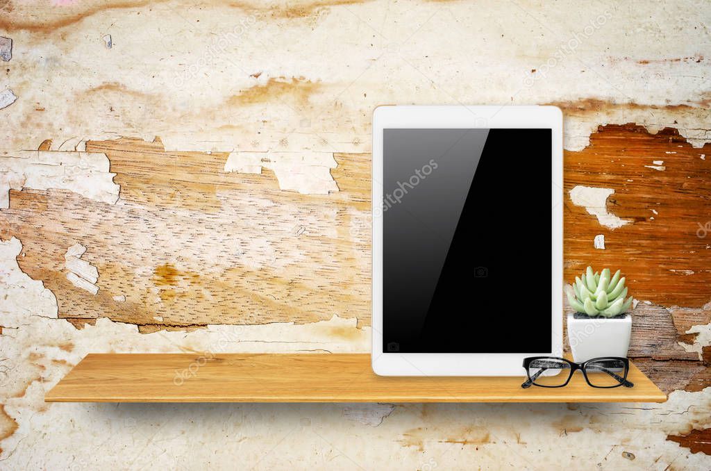 Digital tablet on bookshelf 