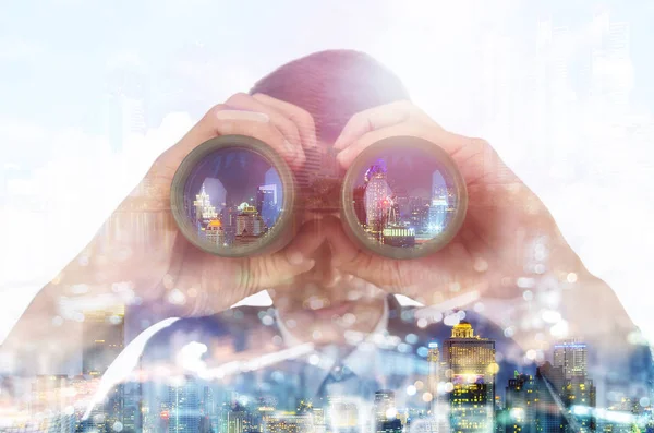 Hombre de negocios con prismáticos y paisaje urbano — Foto de Stock