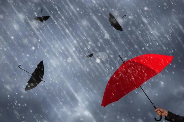 Red umbrella in hand of businessman — Stock Photo, Image