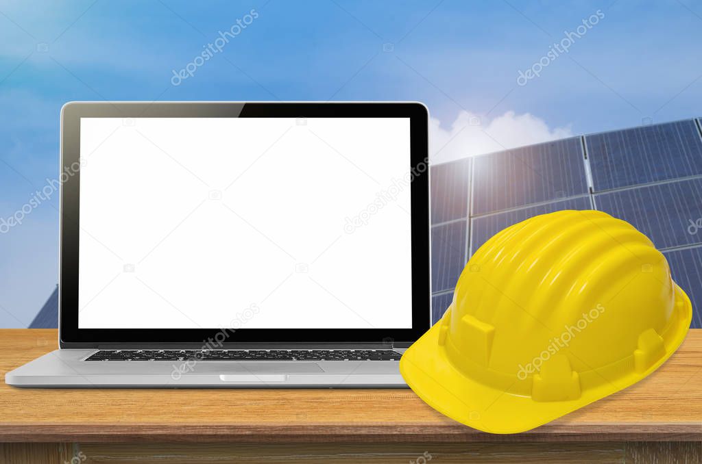 Yellow safety helmet and laptop 