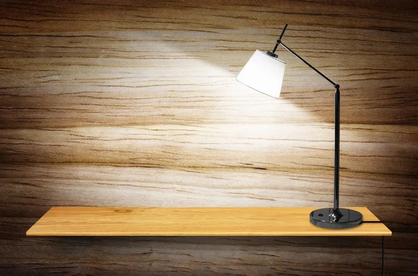 lamp on wooden bookshelf