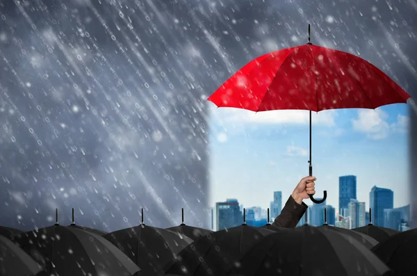 Red umbrella in hand of businessman — Stock Photo, Image