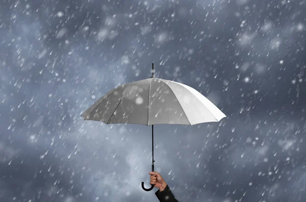 White umbrella in hand of businessman — Stock Photo, Image