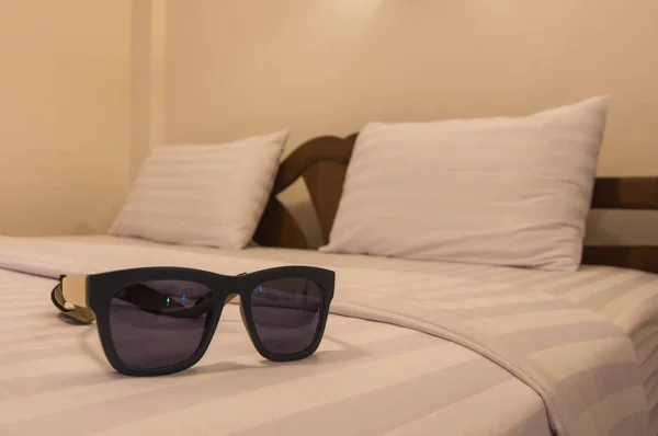 Glasses on the bed.  relaxation. — Stock Photo, Image