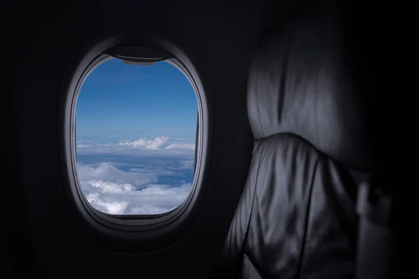 Window View From Passenger Seat On Commercial Airplane with blue sky, Concept of travel and air transportation.