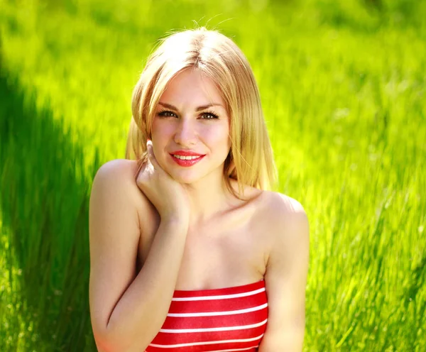 Young woman in dress on meadow in green nature background — Stock Photo, Image