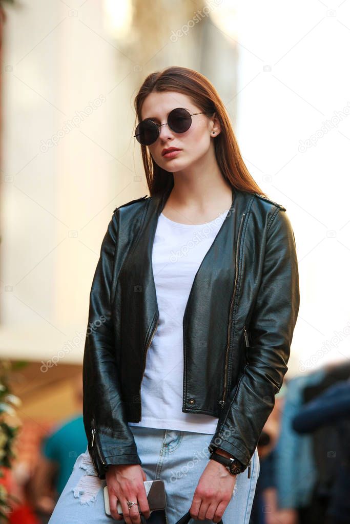 Young woman in retro rock style in the city street square