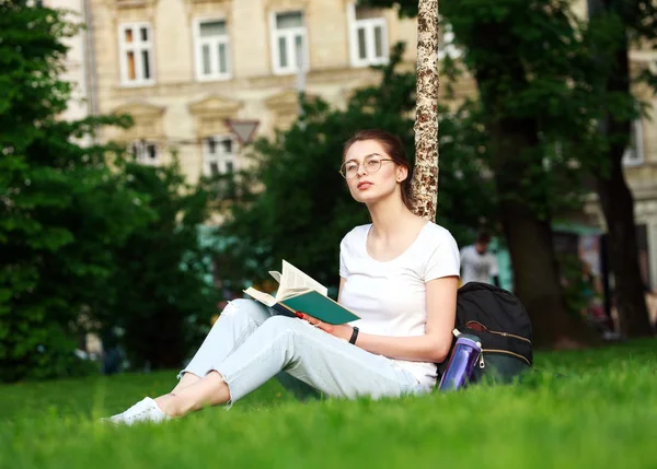 Chica estudiante en el parque de la ciudad con libro — Foto de Stock