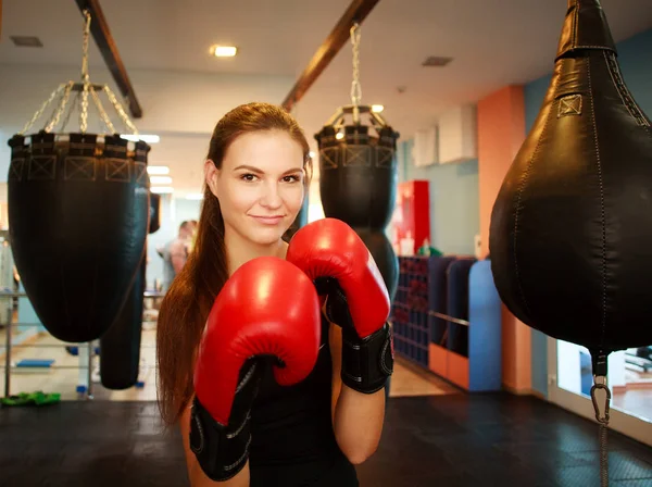 Sport giovane donna in boxe guanti rossi in palestra — Foto Stock