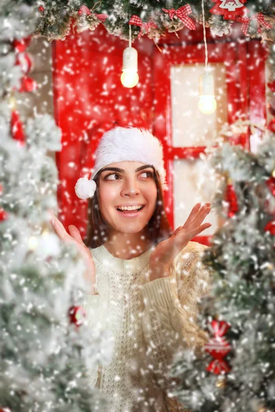 Happy and excited woman on snowfall background Christmas tree — Stock Photo, Image