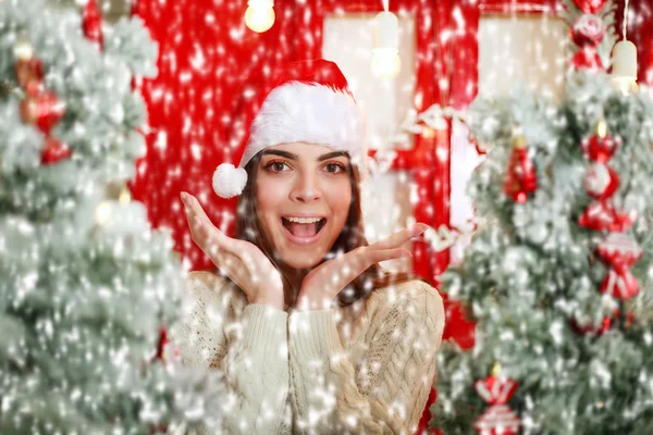 Happy and excited woman on snowfall background Christmas tree — Stock Photo, Image