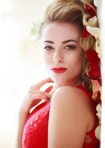 Kobieta piękna moda w czerwone płatki róż na białym — Zdjęcie stockowe