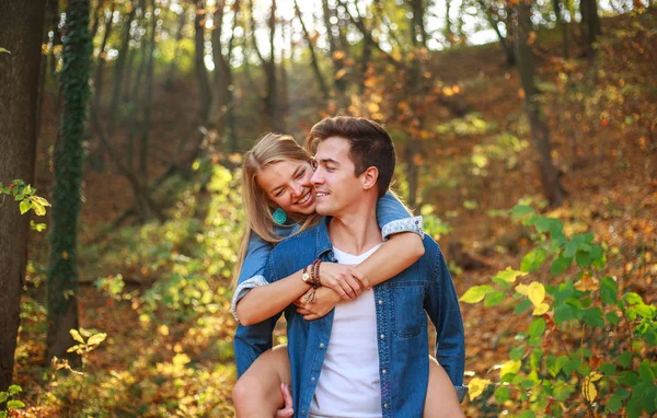 Orman parkındaki mutlu çift erkek ve kız birlikte eğleniyor. — Stok fotoğraf