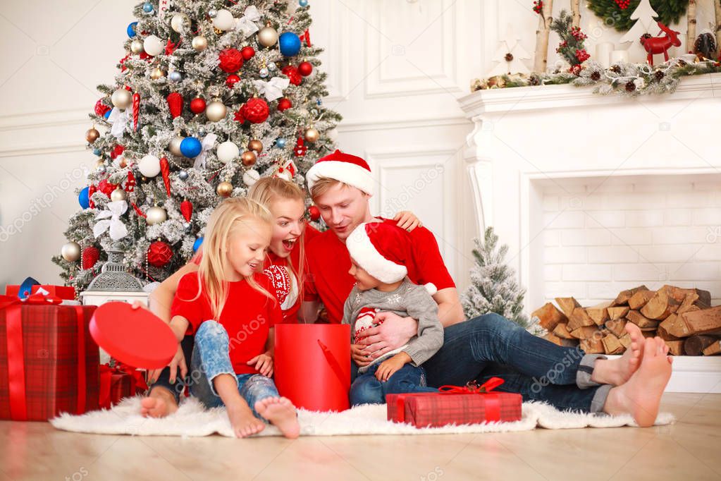 Happy family at home at Christmas near New Year tree