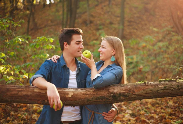 Young happy couple in love in forest with apple, relationship — Stock Photo, Image