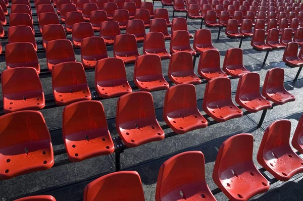 Stylish red rows of chairs for people watching sporting events.