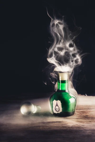 Poison bottle on a wooden surface — Stock Photo, Image