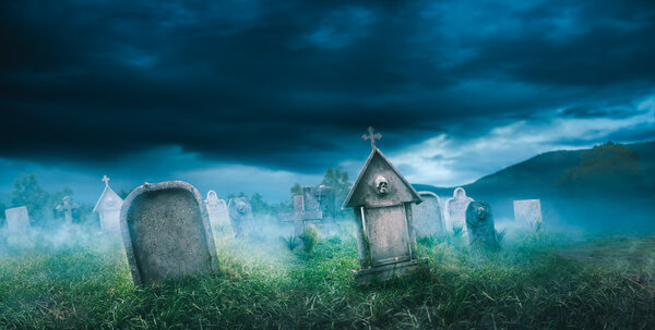 wide view of gravestones with fog 