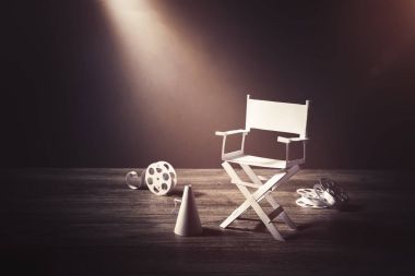image with vintage texture of a Director chair and movie items clipart