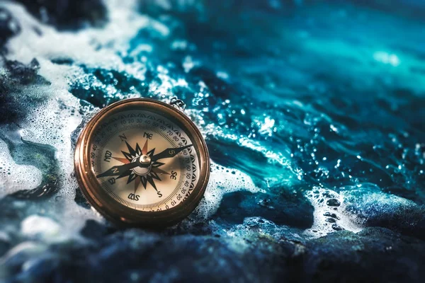 Compass on rocks with a dark sky — Stock Photo, Image