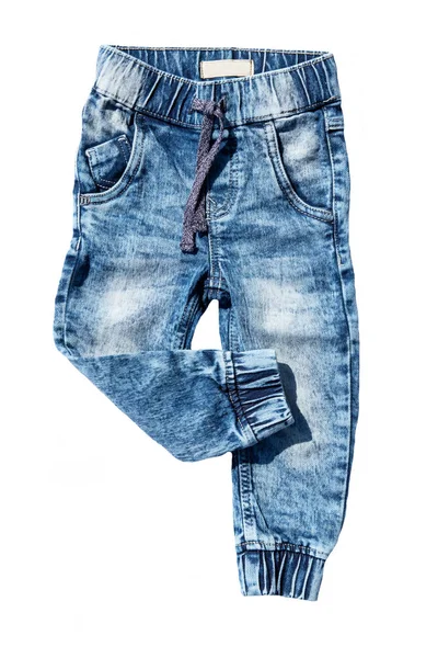 Calça jeans azul isolada em fundo branco. Calças de ganga na moda de rapaz de criança. Perna das calças direita dobrada. Vista superior frontal . — Fotografia de Stock