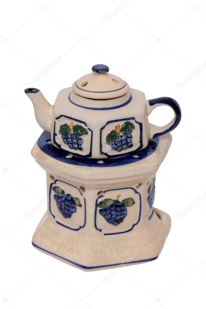 Close-up of a vintage teapot with warmer made of ceramic pottery