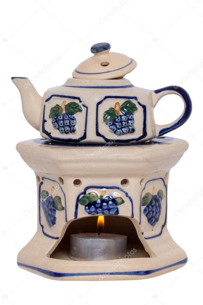 Closeup of a vintage teapot with warmer made of ceramic pottery 