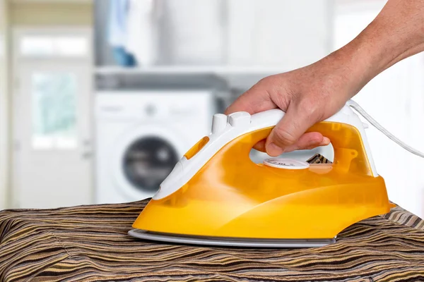 Man ironing clothes. The concept of the work division in a commo — Stock Photo, Image
