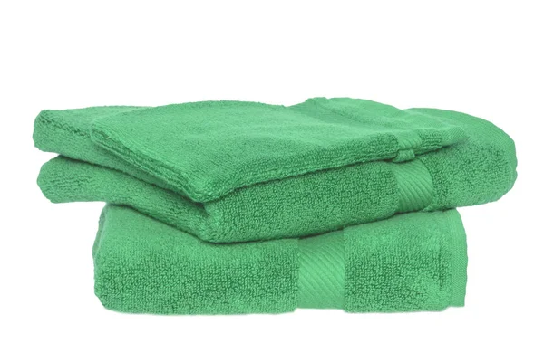 Towels isolated. Closeup of a stack or pile of green soft terry — ストック写真