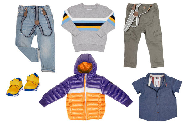 Collage set of children clothes. Denim jeans and pants, a pair shoes , a rain jacket, shirt and a sweater for child boy isolated on a white background. Concept spring autumn and summer clothes.