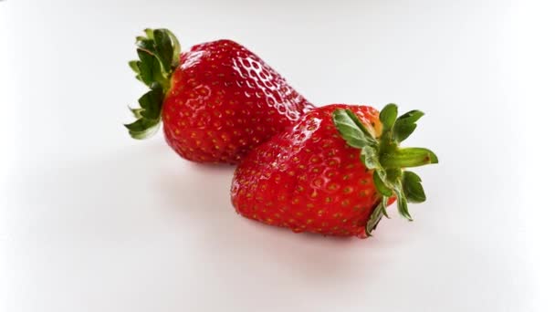 Fresh and ripe organic strawberry rotated on a white background. — 图库视频影像