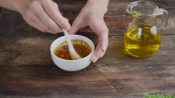 As mãos femininas fazem escabeche de temperos, suco de limão e óleo de azeitona . — Vídeo de Stock