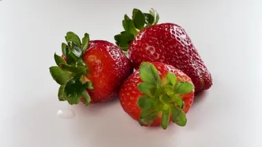 Fresh and ripe organic strawberry rotated on a white background. 