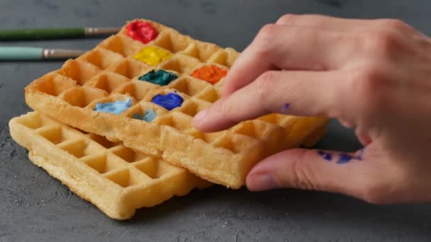 Sweet colored belgian waffles on a gray background. — Stock Video