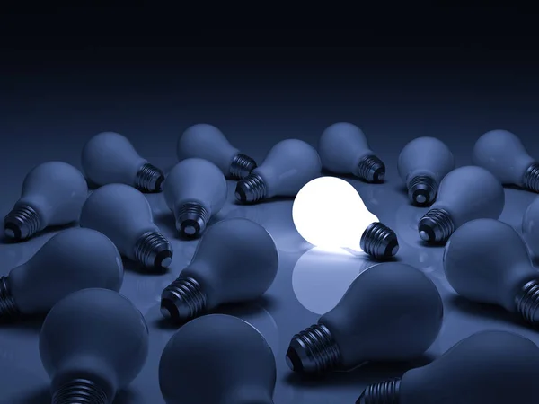 One glowing light bulb standing out from unlit incandescent bulbs with reflection on blue background , individuality and different creative ideas concepts — Stock Photo, Image