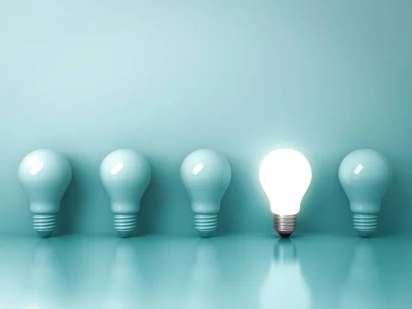 One glowing light bulb standing out from the unlit incandescent bulbs on green background with reflection , individuality and different creative idea concepts — Stock Photo, Image