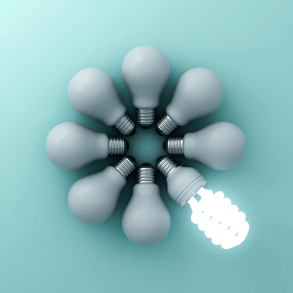 Bombilla de ahorro de energía ecológica, una bombilla fluorescente brillante que se destaca de las bombillas incandescentes no iluminadas sobre fondo verde — Foto de Stock